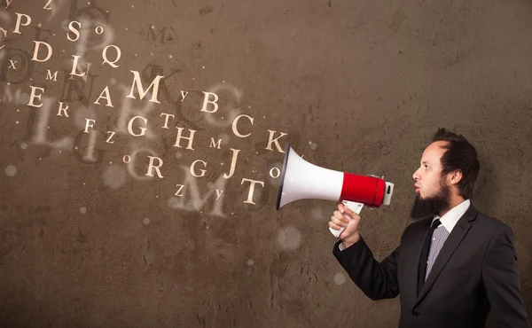 Man in shirt shouting into megaphone and text come out — Stock Photo, Image