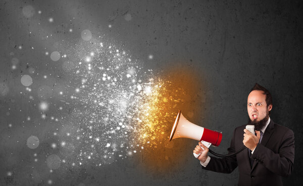 Guy shouting into megaphone and glowing energy particles explode