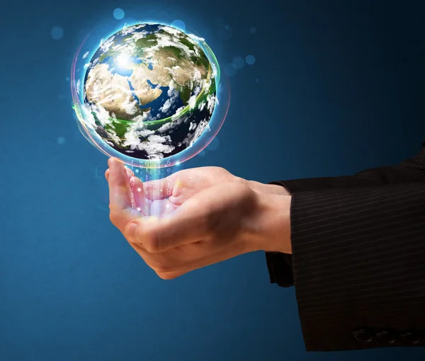 Businessman holding a glowing earth globe — Stock Photo, Image