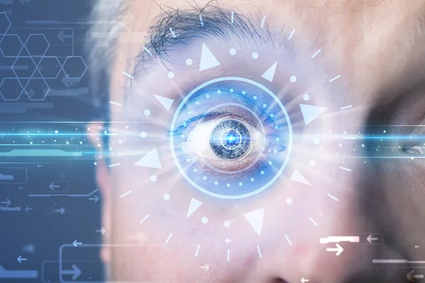 Cyber man with technolgy eye looking into blue iris — Stock Photo, Image