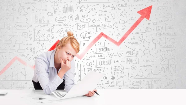 Femme d'affaires assise à table avec des diagrammes de marché — Photo