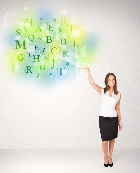 Business women with glowing letter concept — Stock Photo, Image