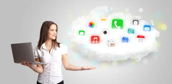 Mulher jovem apresentando nuvem com ícones e símbolos de aplicativos coloridos — Fotografia de Stock