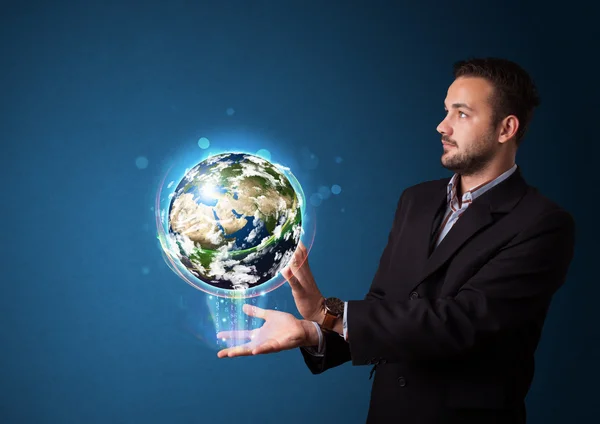 Businessman holding glowing earth globe — Stock Photo, Image