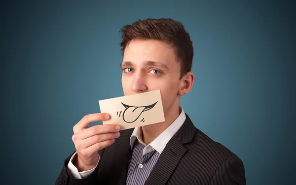 Happy businessman holding funny white card on his mouth — Stock Photo, Image