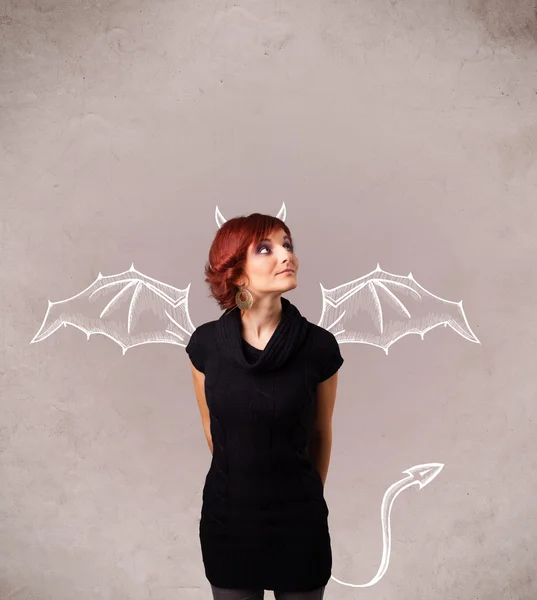 Young girl with devil horns and wings drawing — Stock Photo, Image