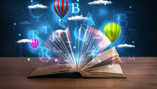 Open book with glowing fantasy abstract clouds and balloons — Stock Photo, Image