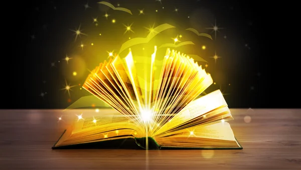 Open book with golden glow flying paper pages