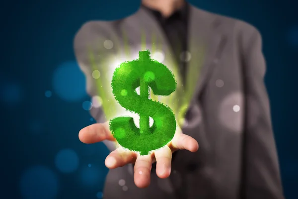 Jonge zakenman presenteren groene gloeiende dollarteken — Stockfoto