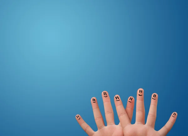 Happy smiley face fingers looking at empty blue background copy — Stock Photo, Image