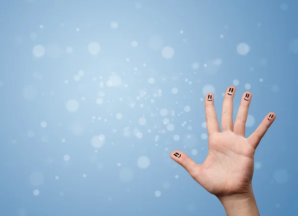 Happy finger smileys with empty blue bokeh background — Stock Photo, Image
