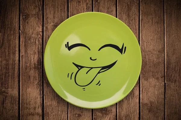 Happy smiley cartoon face on colorful dish plate — Stock Photo, Image