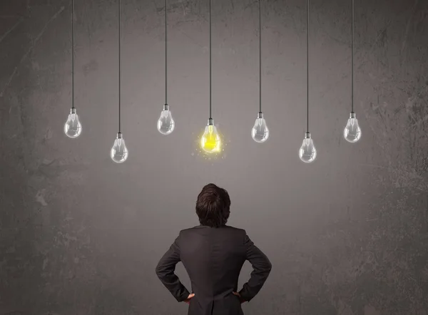 Businness guy in front of idea light bulbs concept — Stock Photo, Image