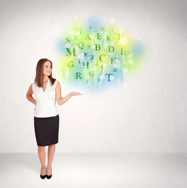 Business women with glowing letter concept — Stock Photo, Image