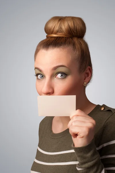 Cute girl holding white card at front of her lips with copy spac — Stock Photo, Image