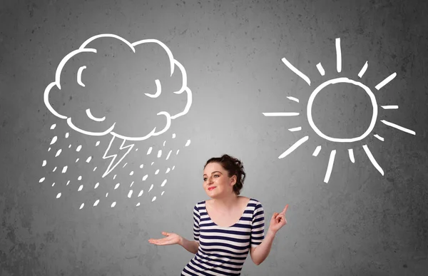 Woman standing between a sun and a rain drawing — Stock Photo, Image