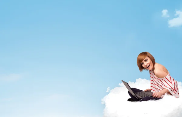 Young woman with laptop sitting on cloud with copy space — Stock Photo, Image