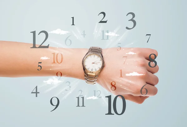 Hand with watch and numbers on the side comming out — Stockfoto