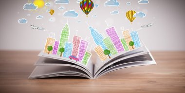 Açık kitap üzerine şehir manzarası çizimi