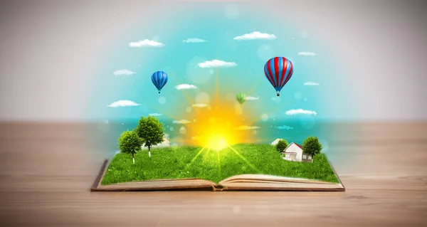 Open book with green nature world coming out of its pages — Stock Photo, Image