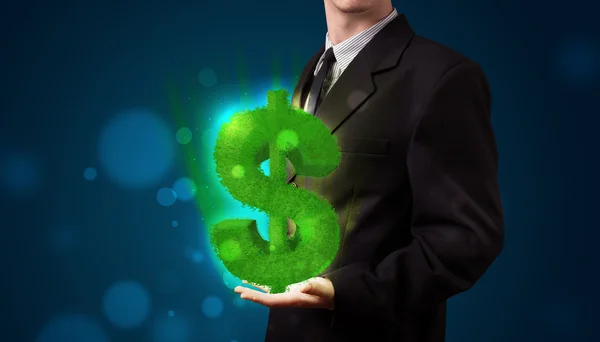 Νέος επιχειρηματίας παρουσιάζοντας λαμπερό πράσινο σύμβολο του δολαρίου — Φωτογραφία Αρχείου