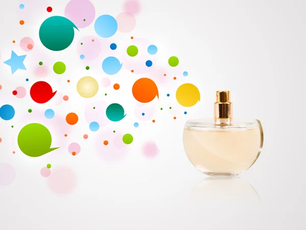 Perfume bottle spraying colored bubbles — Stock Photo, Image