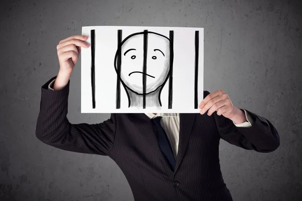 Businessman holding a paper with a prisoner behind the bars on i — Stock Photo, Image