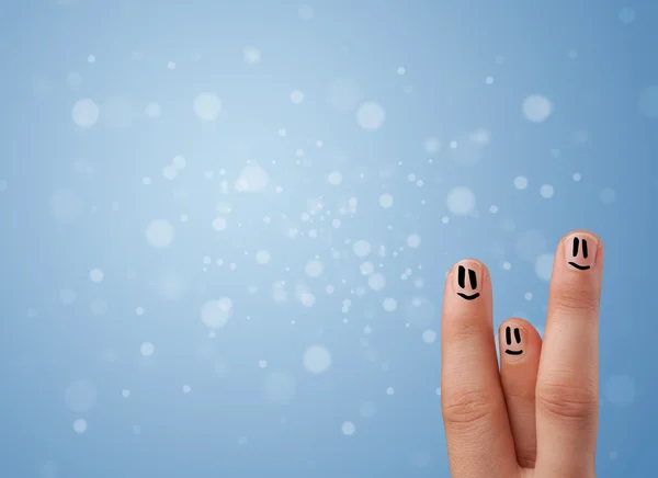 Happy finger smileys with empty blue bokeh background — Stock Photo, Image