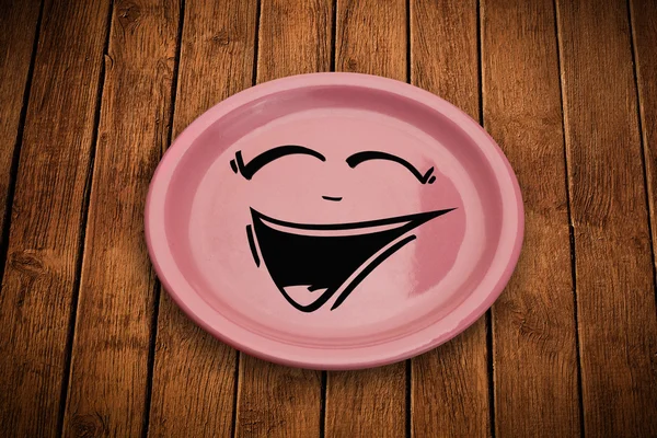 Happy smiley cartoon face on colorful dish plate — Stock Photo, Image