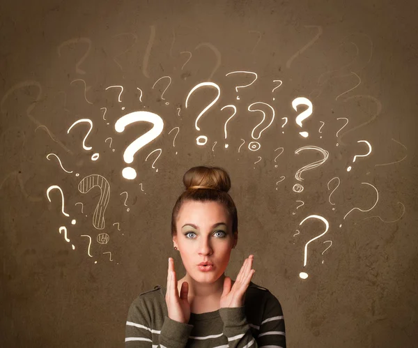 Girl with question mark symbols around her head — Stock Photo, Image