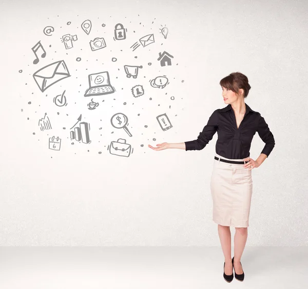 Young business woman presenting hand drawn media icons — Stock Photo, Image