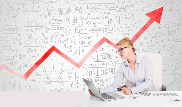 Business woman sitting at table with market diagrams — Stock Photo, Image