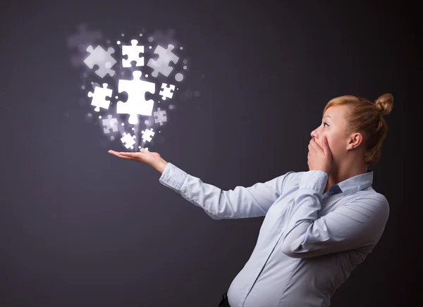 Puzzle pieces in the hand of a businesswoman — Stock Photo, Image