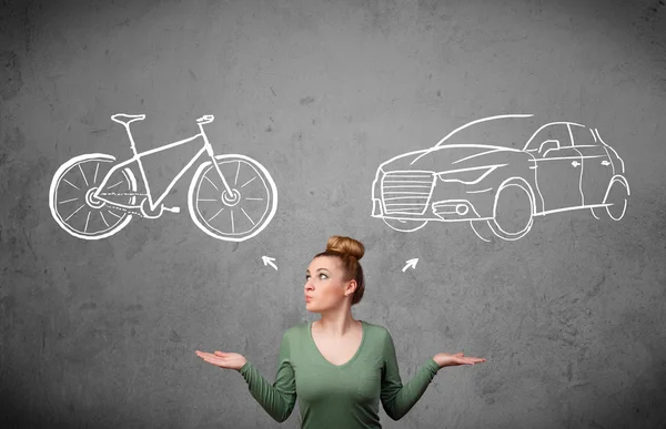 Woman making a choice between bicycle and car — Stock Photo, Image