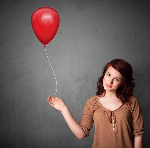 Donna che tiene un palloncino rosso — Foto Stock