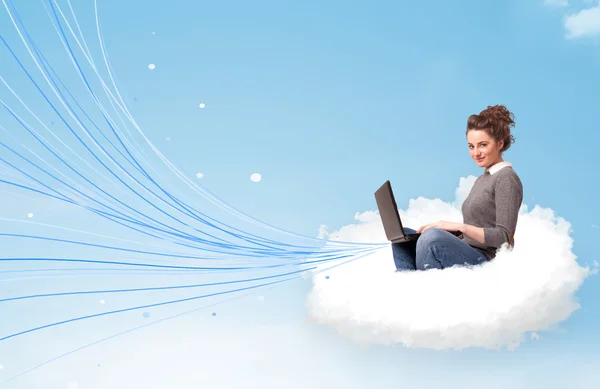 Young woman sitting in cloud with laptop — Stock Photo, Image