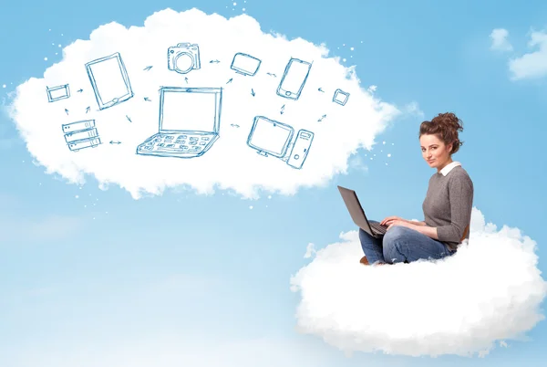 Young woman sitting in cloud with laptop — Stock Photo, Image