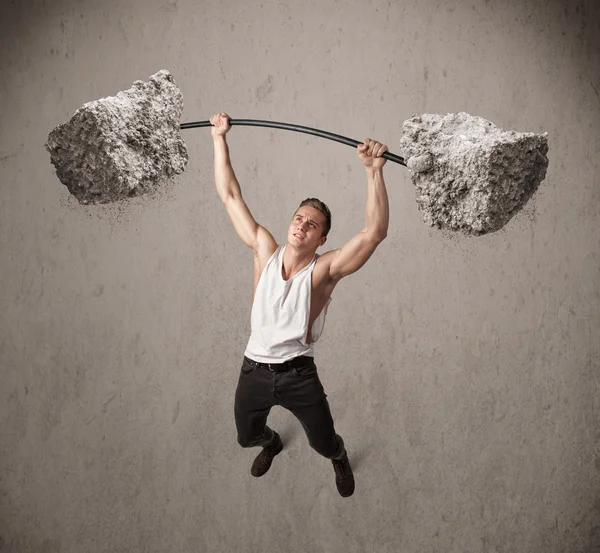 Hombre muscular levantando grandes pesos de piedra de roca —  Fotos de Stock