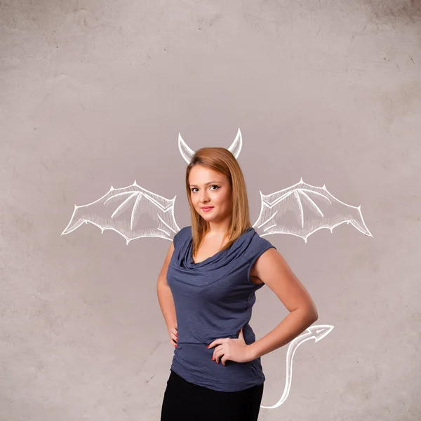 Young girl with devil horns and wings drawing — Stock Photo, Image