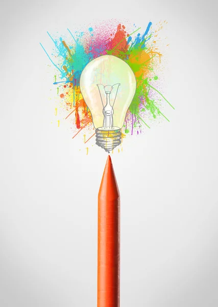 Crayon close-up with colored paint splashes and lightbulb — Stock Photo, Image