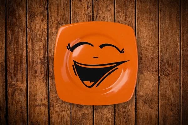 Happy smiley cartoon face on colorful dish plate — Stock Photo, Image