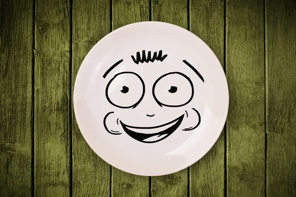 Happy smiley cartoon face on colorful dish plate — Stock Photo, Image