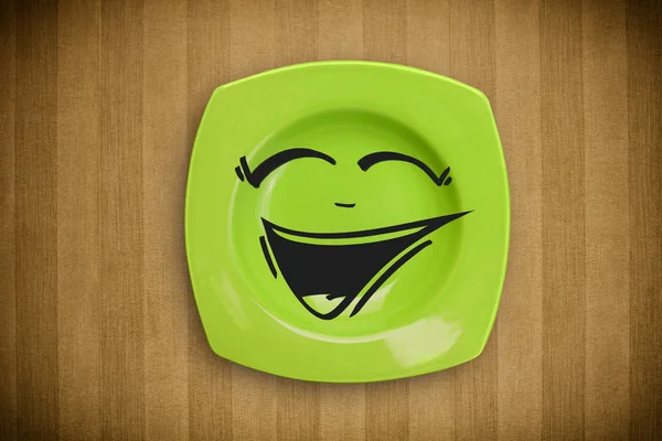 Happy smiley cartoon face on colorful dish plate — Stock Photo, Image