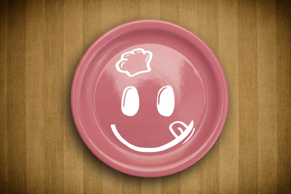 Happy smiley visage de dessin animé sur plaque de plat coloré — Photo