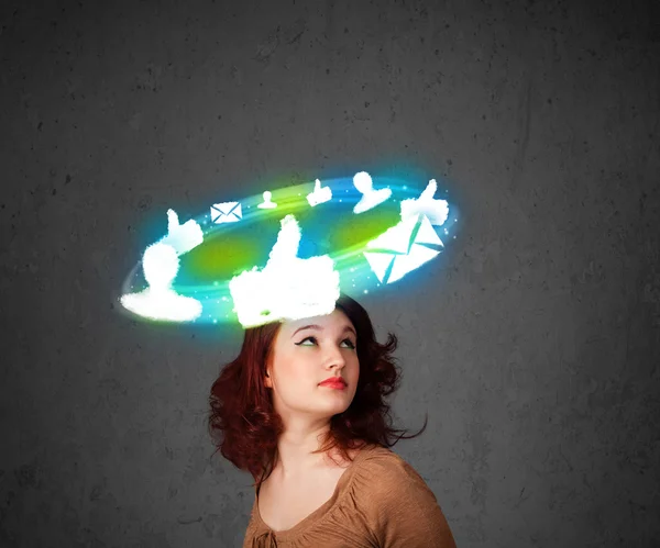 Young teenager with cloud social icons around her head — Stock Photo, Image