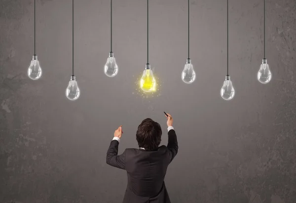 Businness guy in front of idea light bulbs concept — Stock Photo, Image