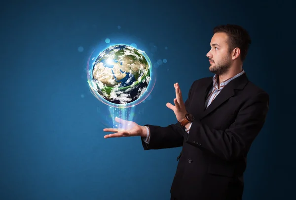 Businessman holding glowing earth globe — Stock Photo, Image