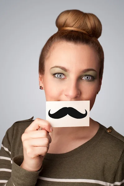 Feliz linda chica sosteniendo papel con bigote dibujo — Foto de Stock