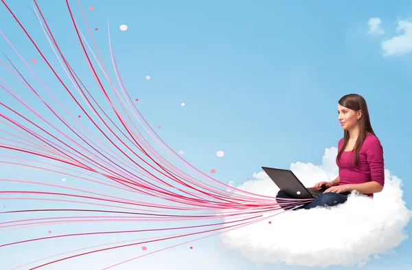 Young woman sitting in cloud with laptop — Stock Photo, Image