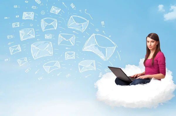 Young woman sitting in cloud with laptop — Stock Photo, Image